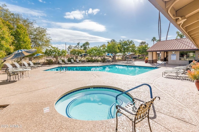 view of pool featuring a hot tub and a patio