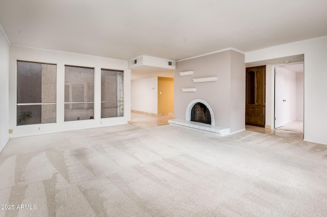 unfurnished living room with light carpet, a brick fireplace, and ornamental molding