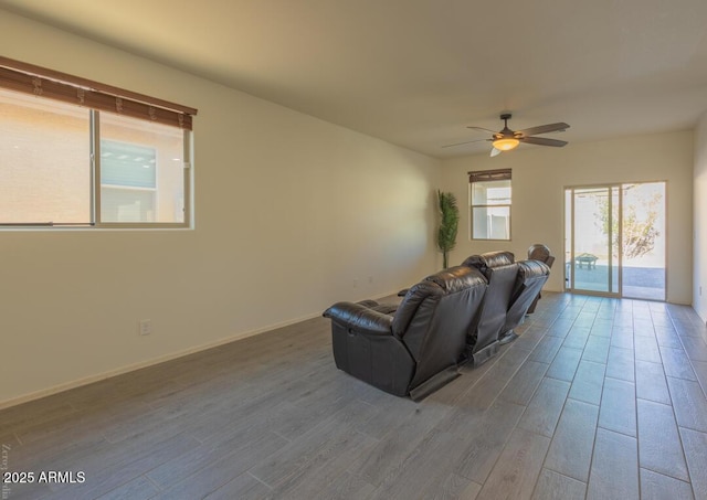 living room featuring wood-type flooring and ceiling fan