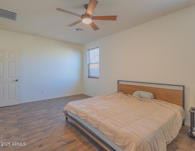 bedroom featuring ceiling fan and dark hardwood / wood-style flooring