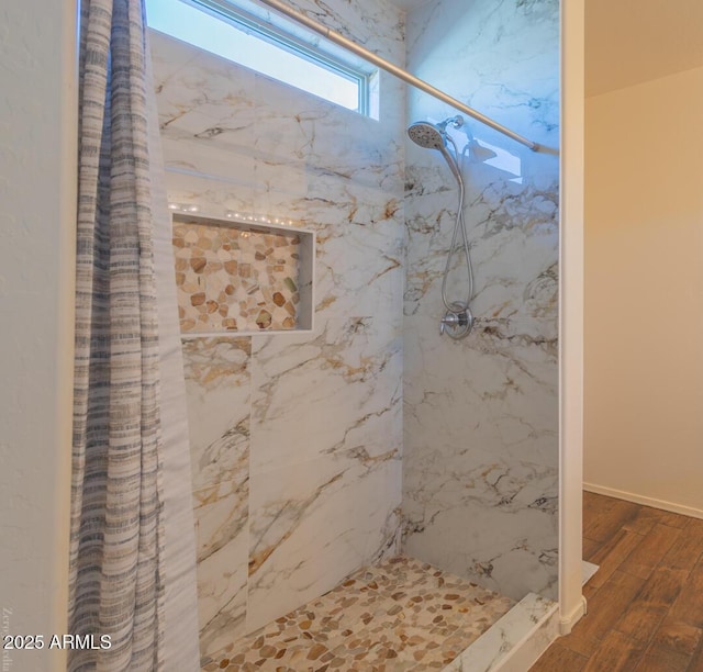 bathroom featuring hardwood / wood-style floors and curtained shower