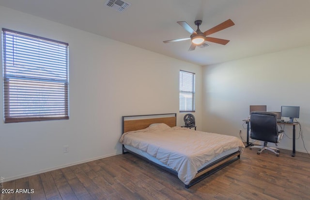 bedroom with dark hardwood / wood-style floors and ceiling fan