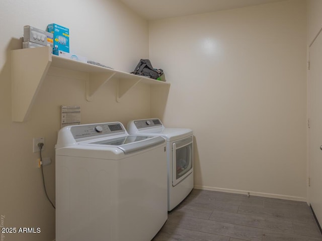 washroom featuring light hardwood / wood-style floors and washer and dryer