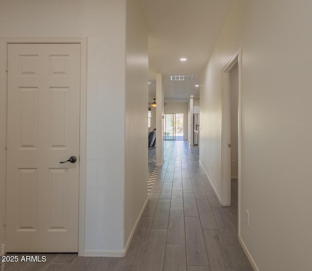 corridor featuring wood-type flooring