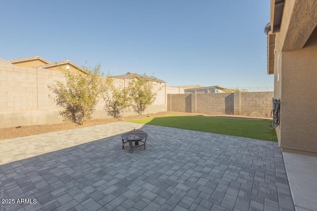 view of patio / terrace featuring an outdoor fire pit