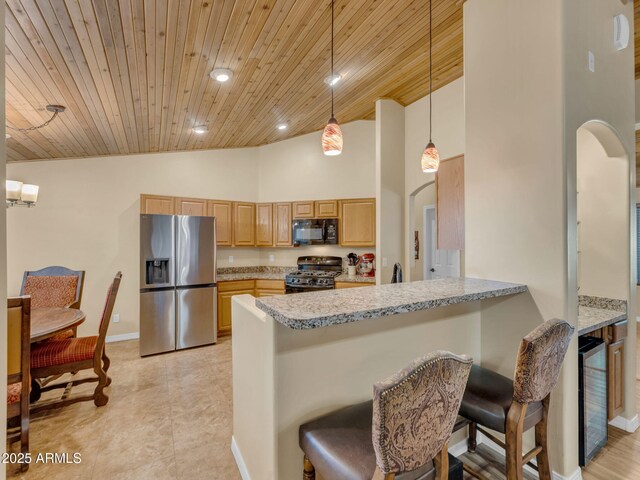 490 E Twelve Oaks Dr, Flagstaff, AZ 86005 - kitchen with stainless steel appliances, wooden ceiling, beverage cooler, arched walkways, and high vaulted ceiling