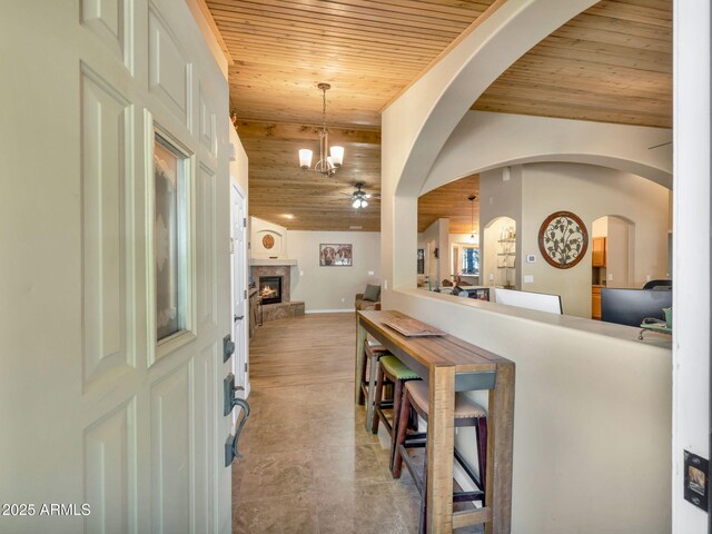 490 E Twelve Oaks Dr, Flagstaff, AZ 86005 - foyer entrance featuring wooden ceiling, a chandelier, a fireplace, and arched walkways