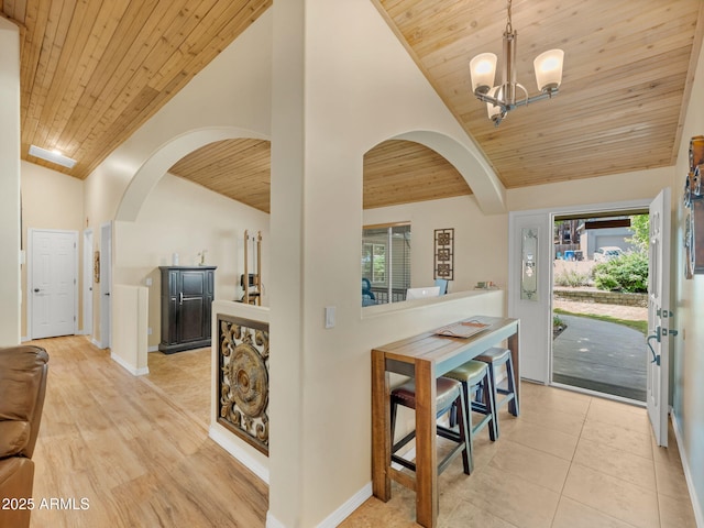 490 E Twelve Oaks Dr, Flagstaff, AZ 86005 - foyer entrance featuring wooden ceiling, arched walkways, lofted ceiling, a chandelier, and light tile patterned floors