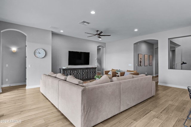 living room with ceiling fan and light hardwood / wood-style flooring