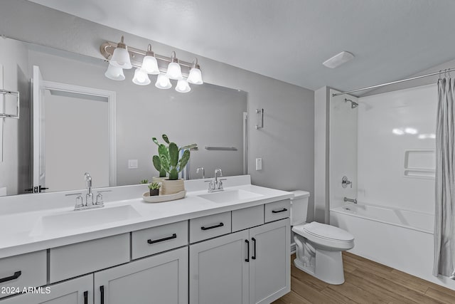 full bathroom featuring bathtub / shower combination, vanity, hardwood / wood-style flooring, and toilet