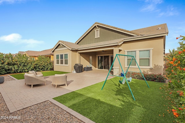 back of property with a lawn, an outdoor living space, and a patio