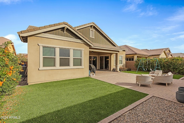 back of house featuring a playground, a patio area, and a yard