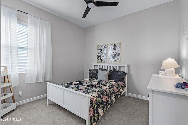 bedroom with ceiling fan and light colored carpet