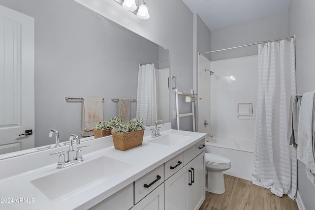 full bathroom with wood-type flooring, vanity, toilet, and shower / bath combo with shower curtain