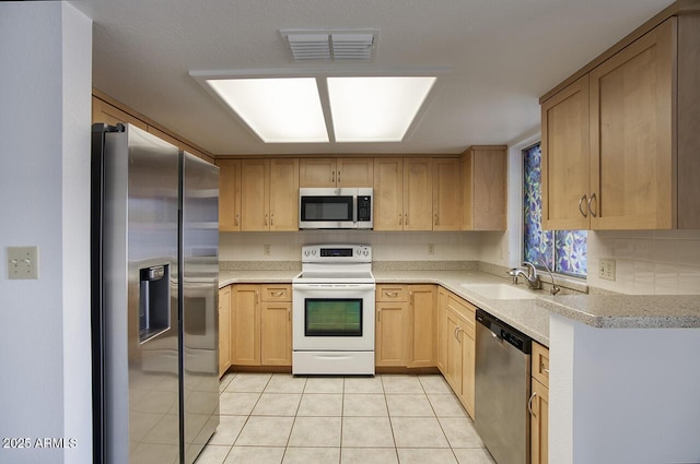 722 W Topeka Dr, Phoenix, AZ 85027 - kitchen featuring appliances with stainless steel finishes, a sink, light countertops, light brown cabinets, and light tile patterned flooring