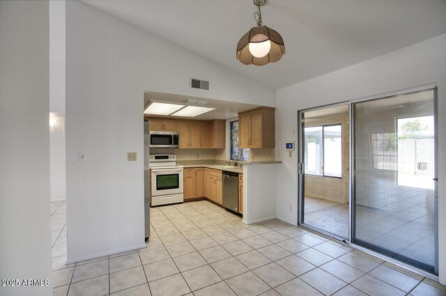 722 W Topeka Dr, Phoenix, AZ 85027 - kitchen featuring stainless steel appliances, vaulted ceiling, light countertops, a sink, and light tile patterned flooring
