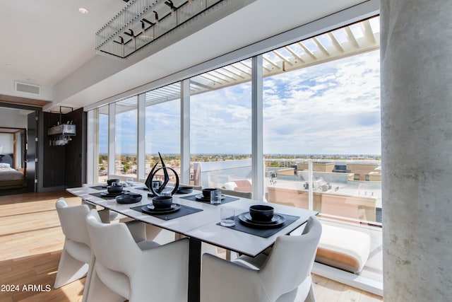 dining space featuring wood finished floors and a water view