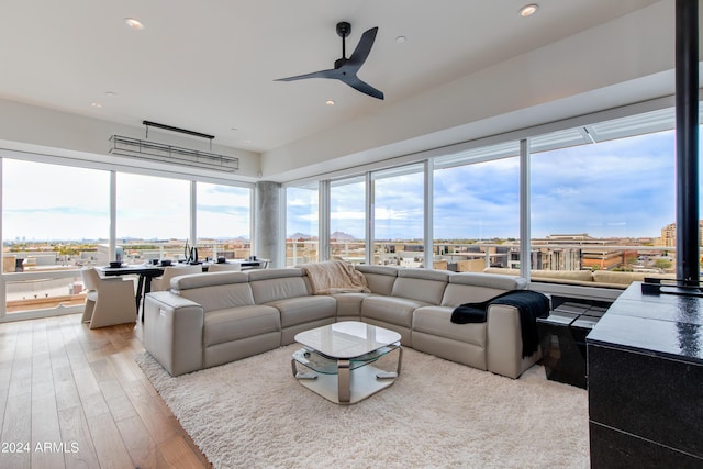 living room featuring ceiling fan, wood finished floors, and recessed lighting