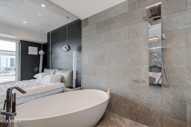 bathroom with a freestanding bath, a tile shower, and recessed lighting