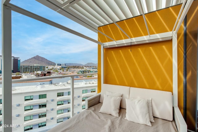 balcony featuring a mountain view and a city view