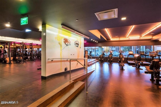 gym with a raised ceiling