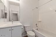 bathroom featuring toilet, vanity, and bathtub / shower combination