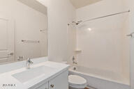 full bathroom with washtub / shower combination, toilet, and vanity