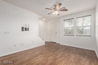 empty room with wood finished floors and ceiling fan