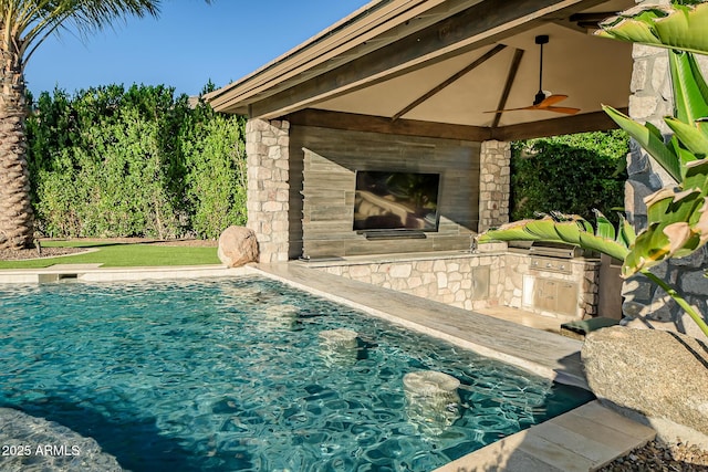 31517 N 41st St, Cave Creek, AZ 85331 - outdoor pool featuring an outdoor kitchen, ceiling fan, a fireplace, and area for grilling