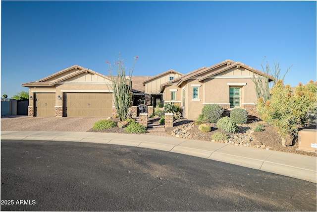 31517 N 41st St, Cave Creek, AZ 85331 - view of front of house with stone siding, decorative driveway, an attached garage, and stucco siding