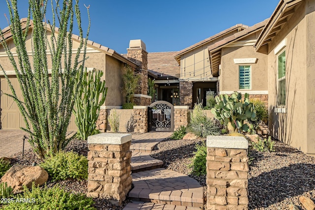 31517 N 41st St, Cave Creek, AZ 85331 - view of front of home featuring stone siding, a gate, stucco siding, and a chimney