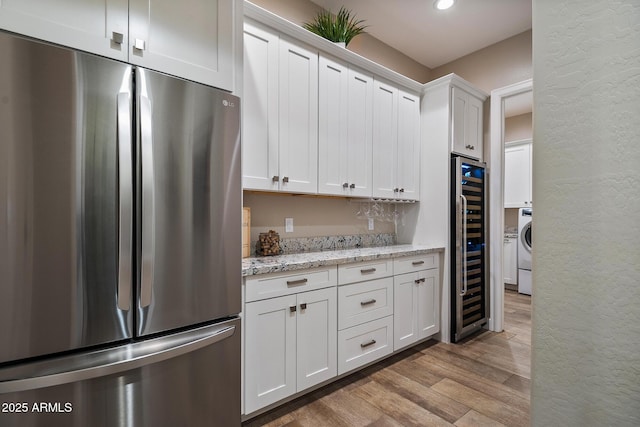 31517 N 41st St, Cave Creek, AZ 85331 - kitchen with freestanding refrigerator, a textured wall, wine cooler, light wood-style floors, and white cabinets