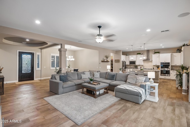 31517 N 41st St, Cave Creek, AZ 85331 - living area featuring light wood-type flooring, recessed lighting, ceiling fan, baseboards, and a chandelier
