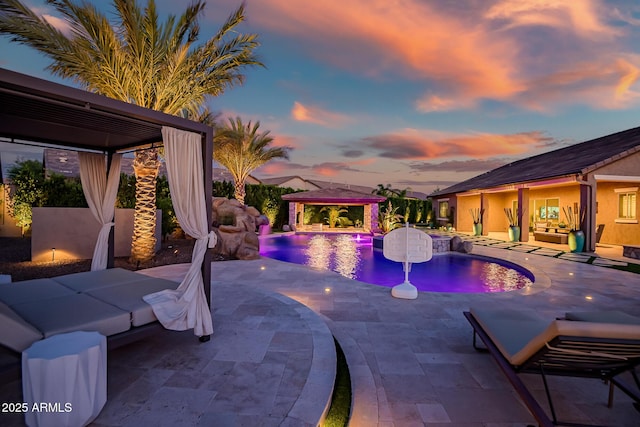 31517 N 41st St, Cave Creek, AZ 85331 - pool at dusk featuring a gazebo, a patio, an outdoor pool, and an outdoor hangout area