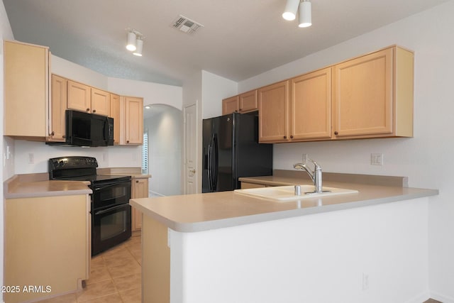 kitchen with sink, kitchen peninsula, light brown cabinets, and black appliances