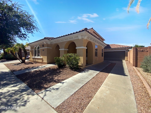 mediterranean / spanish home featuring a garage