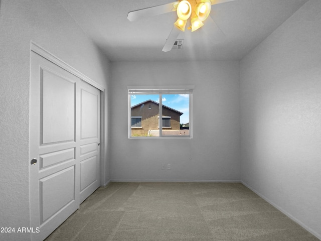 unfurnished bedroom featuring ceiling fan, carpet floors, and a closet