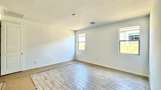 spare room featuring light hardwood / wood-style flooring