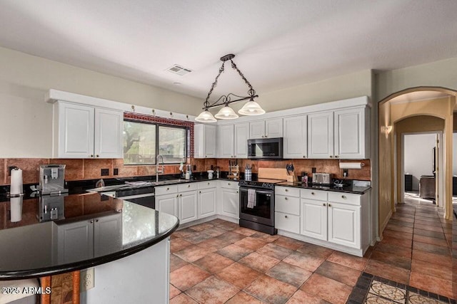 kitchen with kitchen peninsula, hanging light fixtures, stainless steel appliances, white cabinetry, and sink