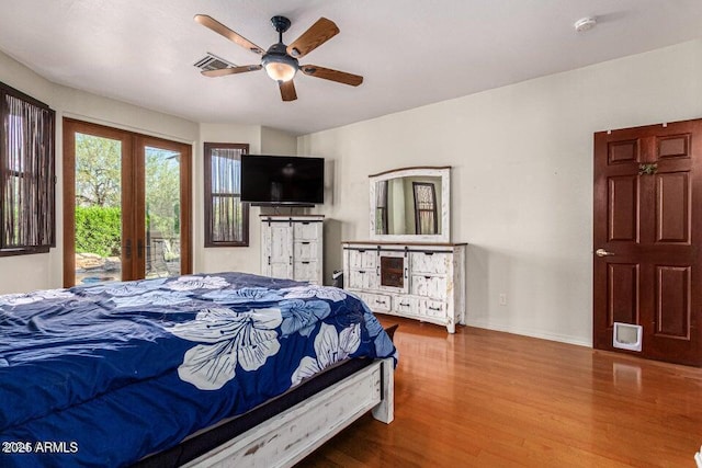 bedroom featuring access to outside, french doors, ceiling fan, and wood-type flooring