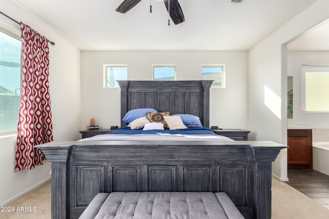 bedroom with light hardwood / wood-style flooring, multiple windows, and ceiling fan