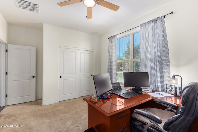 office area featuring light carpet and ceiling fan