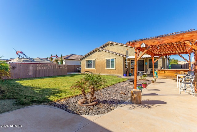 rear view of house featuring an outdoor bar, a patio area, a lawn, and a pergola