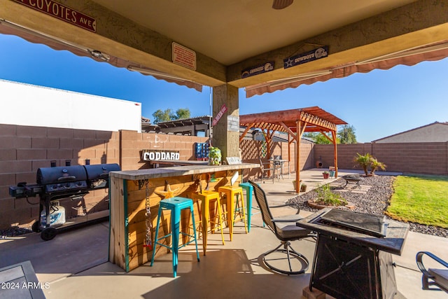 view of patio / terrace with an outdoor bar and grilling area