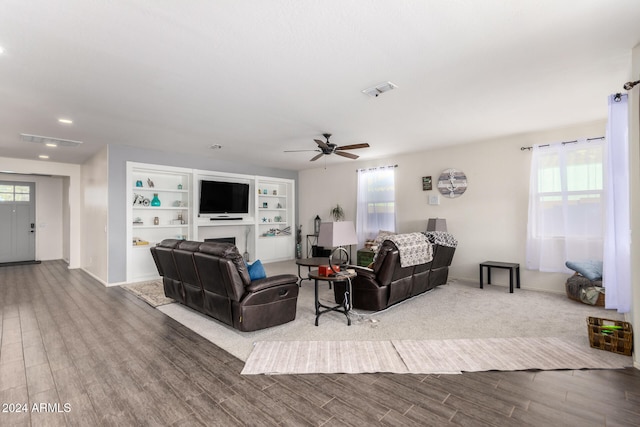 living room featuring hardwood / wood-style flooring and ceiling fan