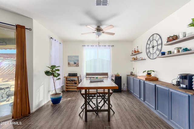 dining area with dark wood-type flooring and ceiling fan