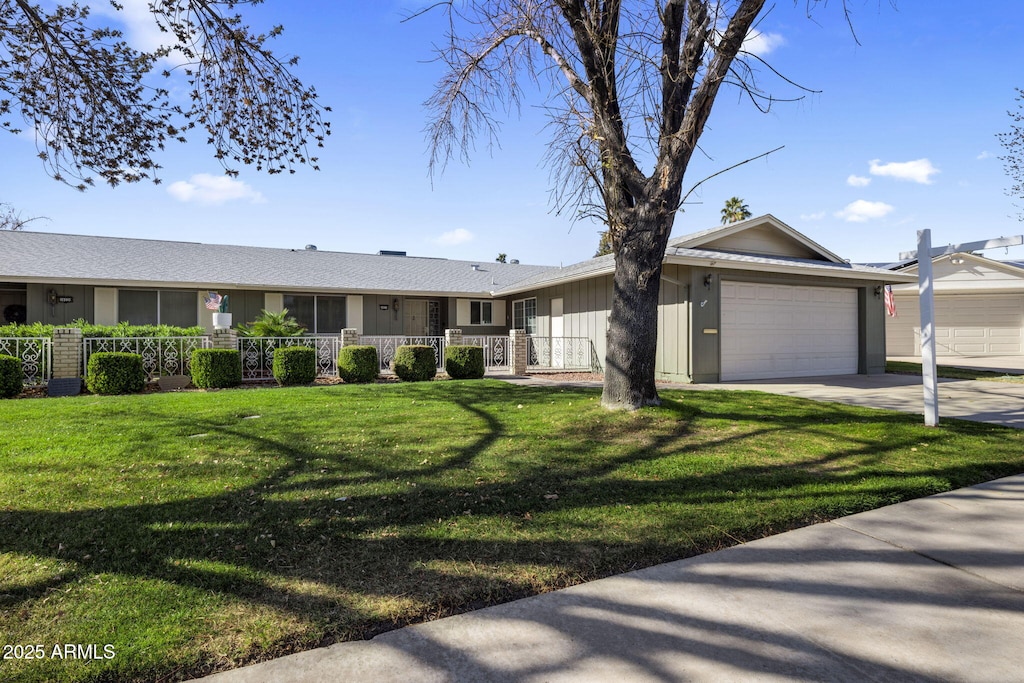 ranch-style house with a garage and a front yard