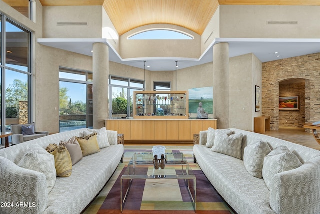 living room with high vaulted ceiling and hardwood / wood-style flooring