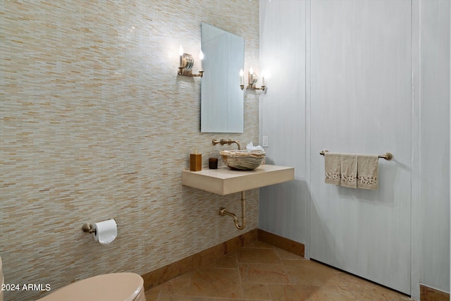 bathroom featuring tile floors, sink, and toilet