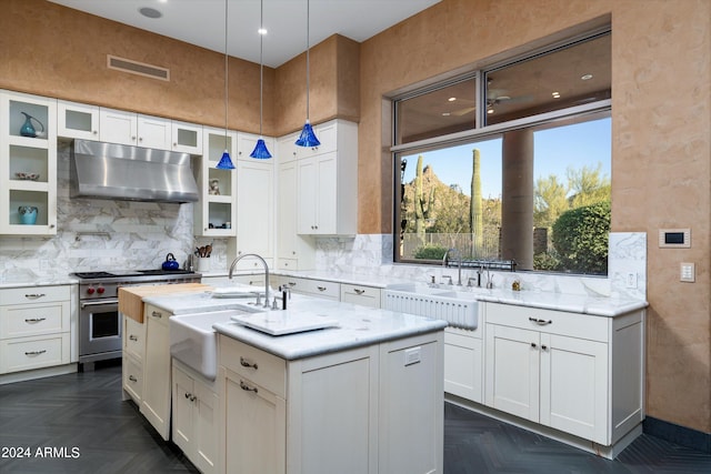 kitchen featuring dark parquet floors, white cabinets, and luxury range